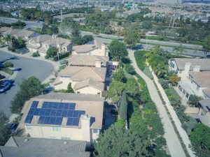 house in neighborhood with a solar roof